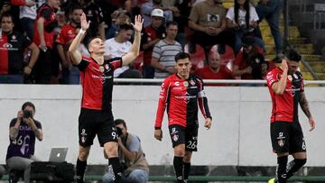 Julio Furch (L) of Atlas celebrates his goal against Tigres with teammates during their Mexican Clausura tournament football match, at the Jalisco stadium, in Guadalajara, Jalisco State, Mexico, on May 18, 2022. (Photo by Ulises Ruiz / AFP)