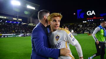 May 25, 2024; Carson, California, USA; LA Galaxy midfielder Riqui Puig (10) and head coach Greg Vanney celebrate after the win against Houston Dynamo FC at Dignity Health Sports Park. Mandatory Credit: Gary A. Vasquez-USA TODAY Sports