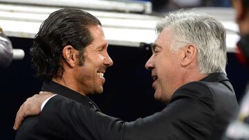 Real Madrid's Italian coach Carlo Ancelotti (R) congratules Atletico Madrid's Argentinian coach Diego Simeone before during the Spanish league football match Real Madrid CF vs Club Atletico de Madrid at the Santiago Bernabeu stadium in Madrid on September 28, 2013.   AFP PHOTO/ GERARD JULIEN