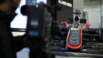 A cameraman films an exhibition model of a McLaren-Honda MP4-30 Formula One racecar, produced by McLaren Group Ltd., displayed during a news conference in Tokyo, Japan, on Tuesday, Feb. 10, 2015. McLaren will have its engines made by Honda Motor Co. next Formula One season, resuming a partnership that won four straight team titles between 1988 and 1991. Photographer: Kiyoshi Ota/Bloomberg