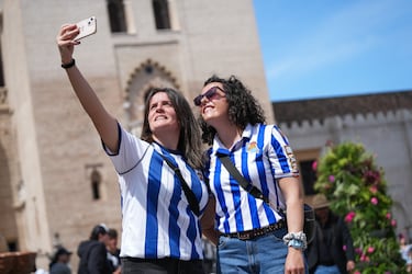 Aficionados de la Real Sociedad posan en distintos puntos emblemáticos de la ciudad.