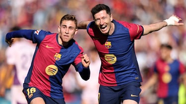 BARCELONA, SPAIN - MARCH 30: Robert Lewandowski of FC Barcelona (R) celebrates scoring his team's second goal with teammate Fermin Lopez during the La Liga EA Sports match between FC Barcelona and Girona FC at Estadi Olimpic Lluis Companys on March 30, 2025 in Barcelona, Spain. (Photo by Judit Cartiel/Getty Images)