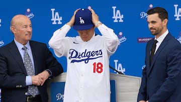 Los Angeles (United States), 27/12/2023.- Newly-signed Los Angeles Dodgers baseball player Yoshinobu Yamamoto (C) puts on his Dodgers'Äô jersey with Dodgers'Äô President and CEO Stan Kasten (L) and Executive Vice President and general manager Brandon Gomes (R) during an introductory press conference at Dodger Stadium in Los Angeles, California, USA, 27 December 2023. Japanese right-handed pitcher Yoshinobu Yamamoto agreed to a 12-year, $325 million contract with the team. This is the largest pitching contract in MLB history in total value. (Japón) EFE/EPA/ALLISON DINNER
