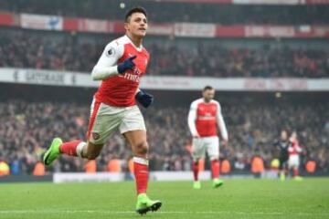 Arsenal's Chilean striker Alexis Sanchez celebrates after scoring their second goal from the penalty spot during the English Premier League football match between Arsenal and Hull City at the Emirates Stadium in London on February 11, 2017. 
Arsenal won the game 2-0. / AFP PHOTO / Glyn KIRK / RESTRICTED TO EDITORIAL USE. No use with unauthorized audio, video, data, fixture lists, club/league logos or 'live' services. Online in-match use limited to 75 images, no video emulation. No use in betting, games or single club/league/player publications.  / 