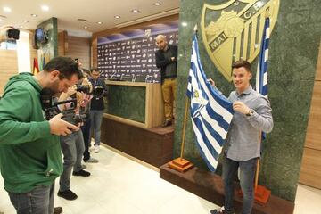 Juanpi posa junto la bandera del Málaga en su renovación.