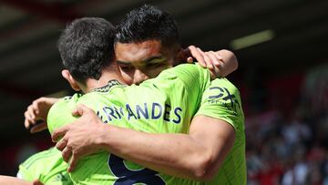 Manchester United's Brazilian midfielder Casemiro (back) celebrates with Manchester United's Portuguese midfielder Bruno Fernandes after scoring the opening goal during the English Premier League football match between Bournemouth and Manchester United at the Vitality Stadium in Bournemouth, southern England, on May 20, 2023. (Photo by Adrian DENNIS / AFP) / RESTRICTED TO EDITORIAL USE. No use with unauthorized audio, video, data, fixture lists, club/league logos or 'live' services. Online in-match use limited to 120 images. An additional 40 images may be used in extra time. No video emulation. Social media in-match use limited to 120 images. An additional 40 images may be used in extra time. No use in betting publications, games or single club/league/player publications. /