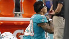 Miami Dolphins wide receiver Kenny Stills, foreground, and wide receiver Albert Wilson kneel during the singing of the national anthem before a preseason NFL game against the Baltimore Ravens, Saturday, Aug. 25, 2018, in Miami Gardens, Fla. (AP Photo/Brynn Anderson)