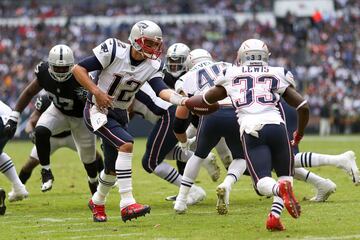 MEXICO CITY, MEXICO - NOVEMBER 19: Tom Brady #12 of the New England Patriots hands the ball off to Dion Lewis #33 against the Oakland Raiders during the first half at Estadio Azteca on November 19, 2017 in Mexico City, Mexico.   Buda Mendes/Getty Images/AFP
== FOR NEWSPAPERS, INTERNET, TELCOS & TELEVISION USE ONLY ==