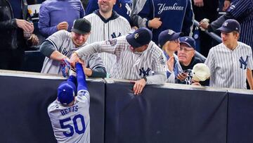 NEW YORK, NEW YORK - OCTOBER 29: Fans interfere with Mookie Betts #50 of the Los Angeles Dodgers as he attempts to catch a fly ball in foul territory during the first inning of Game Four of the 2024 World Series against the New York Yankees at Yankee Stadium on October 29, 2024 in the Bronx borough of New York City. The play resulted in an out. Al Bello/Getty Images/AFP (Photo by AL BELLO / GETTY IMAGES NORTH AMERICA / Getty Images via AFP)