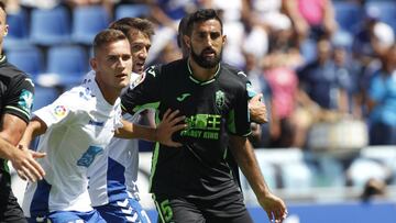 Jorge Saenz, jugador del Tenerife,marcando a un jugador del Granada.