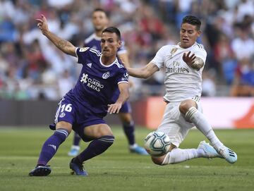 El jugador del Real Valladolid, San Emeterio, lanza el balón ante el jugador del Real Madrid, James Rodríguez. 
