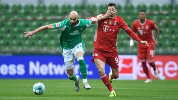 Bremen's Turkish defender Omer Toprak (L) touches the face of Bayern Munich's Polish forward Robert Lewandowski as they vie for the ball during the German first division Bundesliga football match between WErder Bremen vs Bayern Munich in Bremen,