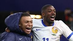 France's forward #10 Kylian Mbappe (L) and France's forward #11 Ousmane Dembele celebrate after winning the UEFA Euro 2024 quarter-final football match between Portugal and France at the Volksparkstadion in Hamburg on July 5, 2024. (Photo by FRANCK FIFE / AFP)