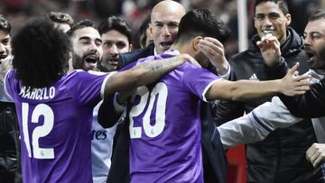 Real Madrid&#039;s Marco Asensio celebrates with players and manager.