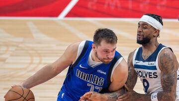 Dallas Mavericks' guard Luka Doncic #77 is guarded by Minnesota Timberwolves' guard Nickeil Alexander-Walker #9 during the NBA Preseason game Between the Dallas Mavericks and the Minnesota Timberwolves