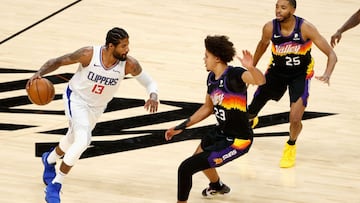 PHOENIX, ARIZONA - JUNE 20: Paul George #13 of the LA Clippers handles the ball against Cameron Johnson #23 of the Phoenix Suns during the second half of game one of the Western Conference Finals at Phoenix Suns Arena on June 20, 2021 in Phoenix, Arizona.