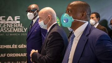 Gianni Infantino (2-L), the president of FIFA and Patrice Motsepe (R) president of the Confederation of African Football (CAF) arrive at the 43th edition general assembly on March 12, 2021, in the Moroccan capital Rabat. (Photo by FADEL SENNA / AFP)