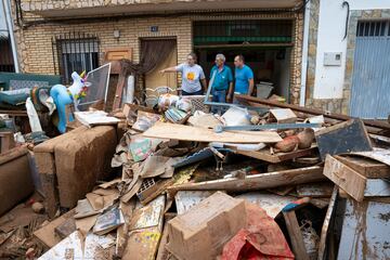 Varias personas observan objetos de una vivienda inundada en Buenache de Alarcón, Cuenca, Castilla La-Mancha.