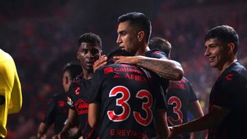 Emanuel Reynoso celebrates his goal 3-0 with Jose Zuniga of Tijuana during the Quarter final first leg round match between Tijuana and Cruz Azul as part of the Liga BBVA MX, Torneo Apertura 2024 at Caliente Stadium on November 27, 2024 in Tijuana, Baja California, Mexico.