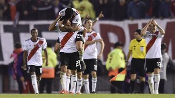 Enzo Perez of Argentina&#039;s River Plate jumps on the back of teammate Leonardo Ponzio to celebrate their team&#039;s third goal, made by Matias Suarez, against Brazil&#039;s Athletico Paranaense, during the Recopa Sudamericana final soccer match in Buenos Aires, Argentina, Thursday, May 30, 2019. (AP Photo/Gustavo Garello)