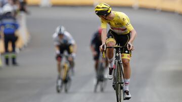 Cycling - Tour de France - Stage 18 - Pau to Luz Ardiden - France - July 15, 2021 UAE Team Emirates rider Tadej Pogacar of Slovenia wearing the yellow jersey looks back at Team Jumbo&acirc;Visma rider Jonas Vingegaard of Denmark wearing the white jersey