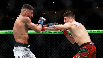 Nov 2, 2024; Edmonton, Alberta, Canada; Brandon Moreno (red gloves) fights Amir Albazi (blue gloves) in a flyweight bout during UFC Fight Night at Rogers Place. Mandatory Credit: Perry Nelson-Imagn Images