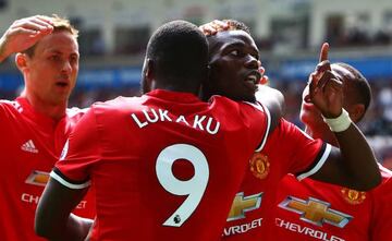 Manchester United's French midfielder Paul Pogba (R) celebrates with Manchester United's Belgian striker Romelu Lukaku (L) scoring the team's fourth goal during the English Premier League football match between Swansea City and Manchester United