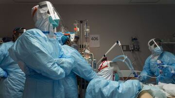 HOUSTON, TX - DECEMBER 22: (EDITORIAL USE ONLY) Medical staff members work to extract a muscle sample from a patient for a muscle biopsy examination in the COVID-19 intensive care unit (ICU) at the United Memorial Medical Center on December 22, 2020 in Houston, Texas. According to reports, Texas has reached over 1,610,000 cases, including over 26,190 deaths. Go Nakamura/Getty Images/AFP
== FOR NEWSPAPERS, INTERNET, TELCOS & TELEVISION USE ONLY ==