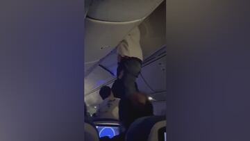 Severe turbulence threw a passenger into an overhead compartment
