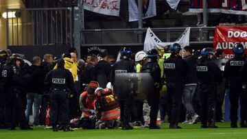 French police officers and members of the stadium staff stand by rescuers as they take care of wounded LOSC&#039; supporters following the fall of their tribune during the French L1 football match between Amiens and Lille LOSC on September 30, 2017 at the