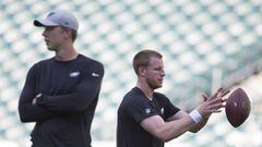 PHILADELPHIA, PA - AUGUST 30: Nick Foles #9 of the Philadelphia Eagles looks on while Carson Wentz #11 warms up behind him prior to the preseason game at Lincoln Financial Field on August 30, 2018 in Philadelphia, Pennsylvania.   Mitchell Leff/Getty Images/AFP == FOR NEWSPAPERS, INTERNET, TELCOS &amp; TELEVISION USE ONLY ==