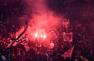 Paris Saint-Germain's supporters burn flares during the game.