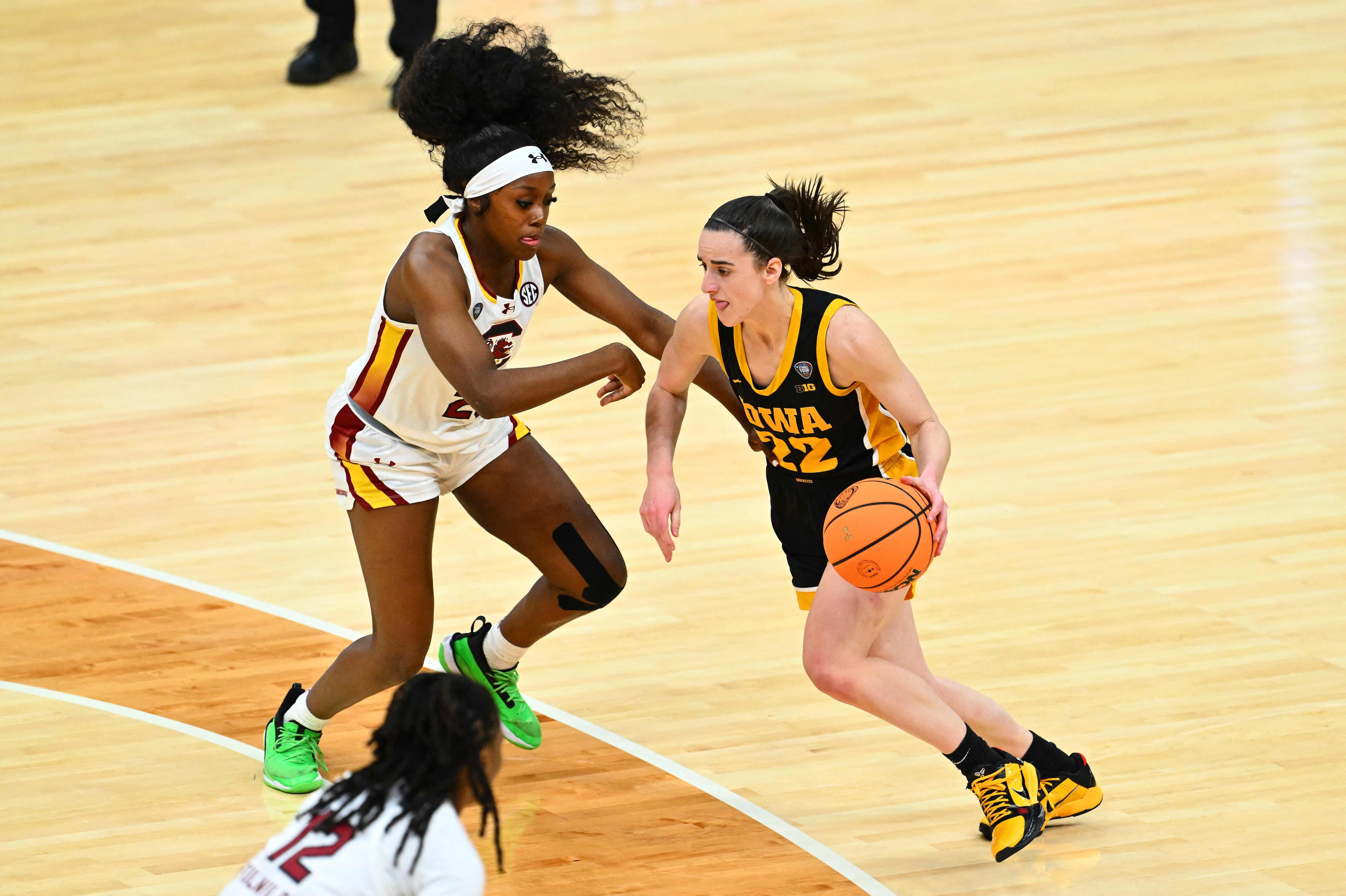 CLEVELAND, OHIO - APRIL 07: Caitlin Clark #22 of the Iowa Hawkeyes dribbles around Raven Johnson #25 of the South Carolina Gamecocks in the first half during the 2024 NCAA Women's Basketball Tournament National Championship at Rocket Mortgage FieldHouse on April 07, 2024 in Cleveland, Ohio.   Jason Miller/Getty Images/AFP (Photo by Jason Miller / GETTY IMAGES NORTH AMERICA / Getty Images via AFP)