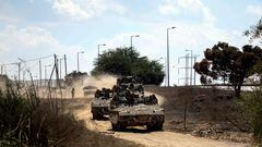 Israeli military vehicles drive near Israel's border with the Gaza Strip, in southern Israel, October 15, 2023. REUTERS/Ronen Zvulun