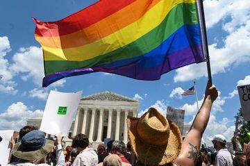 A rainbow flag is held aloft at pro-abortion protests.