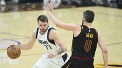 Mar 30, 2022; Cleveland, Ohio, USA; Dallas Mavericks guard Luka Doncic (77) drives against Cleveland Cavaliers forward Kevin Love (0) in the first quarter at Rocket Mortgage FieldHouse. Mandatory Credit: David Richard-USA TODAY Sports