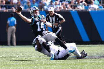CHARLOTTE, NORTH CAROLINA - OCTOBER 10: Sam Darnold #14 of the Carolina Panthers throws under pressure from Fletcher Cox #91 of the Philadelphia Eagles during a football game at Bank of America Stadium on October 10, 2021 in Charlotte, North Carolina.