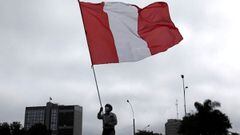 FILE PHOTO: A demonstrator waves a Peruvian flag during a protest against the government of President Pedro Castillo, in Lima, Peru October 8, 2021. REUTERS/Angela Ponce/File Photo