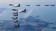 UNDISCLOSED LOCATION, SOUTH KOREA- NOVEMBER 19: In this handout image released by the South Korean Defense Ministry, Two U.S. B-1B Lancer strategic bombers, four U.S. Air Force F-16 fighter jets and four South Korean Air Force F-35 fighter jets fly over South Korea during the joint air drills in response to North Korea's intercontinental ballistic missile (ICBM) launch on November 19, 2022 at an undisclosed location in South Korea. South Korea and the United States conducted a joint air drills focusing on enhancing the capabilities of striking North Korea's missile-related facilities, a day after it fired ICBM. (Photo by South Korean Defense Ministry via Getty Images)