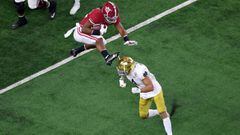 ARLINGTON, TEXAS - JANUARY 01: Running back Najee Harris #22 of the Alabama Crimson Tide leaps cornerback Nick McCloud #4 of the Notre Dame Fighting Irish during the first quarter of the 2021 College Football Playoff Semifinal Game at the Rose Bowl Game p