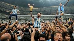 Argentina's Lionel Messi celebrates with the trophy in front of the fans after winning the World Cup final soccer match between Argentina and France at the Lusail Stadium in Lusail, Qatar, Sunday, Dec. 18, 2022. Argentina won 4-2 in a penalty shootout after the match ended tied 3-3. (AP Photo/Martin Meissner) 

Associated Press/LaPresse

EDITORIAL USE ONLY/ONLY ITALY AND SPAIN