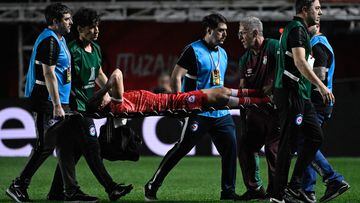 Argentinos Juniors' defender Luciano Sanchez is carried out on a stretcher after being injured during the Copa Libertadores round of 16 first leg football match between Argentina's Argentinos Juniors and Brazil's Fluminense at the Diego Armando Maradona stadium in Buenos Aires, on August 1, 2023. (Photo by Luis ROBAYO / AFP)