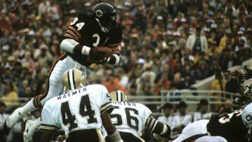 Chicago Bears running back Walter Payton (34), who was inducted into the Pro Football Hall of Fame class of 1993,  dives for a touchdown during a 20-7 victory over the New Orleans Saints on October 7, 1984, at Soldier Field in Chicago, Illinois.  During this game, Payton broke Jim Brown&#039;s career rushing record. (Photo by Bruce Dierdorff/Getty Images)