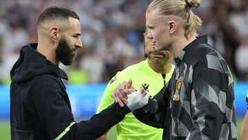 Manchester City's Norwegian striker Erling Haaland (R) shakes hands with Real Madrid's French forward Karim Benzema prior the UEFA Champions League semi-final first leg football match between Real Madrid CF and Manchester City at the Santiago Bernabeu stadium in Madrid on May 9, 2023. (Photo by Thomas COEX / AFP)