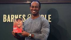 The 14-time major champ  golfer Tiger Woods holds a copy of his new book &quot;The 1997 Masters: My Story&quot;  before his booking signing at Barnes &amp; Noble&#039;s Union Square in New York on March 20, 2017. / AFP PHOTO / TIMOTHY A. CLARY