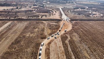 This aerial picture shows funeral processions queueing at the entrance of the Olifantsvlei Cemetery in Soweto, on July 25, 2020. - South Africa&#039;s public schools will close again for a month from July 27 to limit the spread of coronavirus as the count