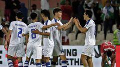 Uzbekistan team players celebrate their 2-1 win during the 2019 AFC Asian Cup group F football match between Uzbekistan and Oman at Sharjah stadium in Sharjah on January 9, 2019. (Photo by Karim Sahib / AFP)