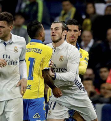 Real Madrid's Gareth Bale gives Jonathan Viera a friendly push.