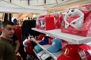 A man looks at Qatar 2022 mascot La'eeb in an official store