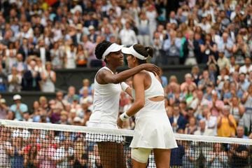 A victorious Garbine Muguruza of Spain is embraced by Venus Williams